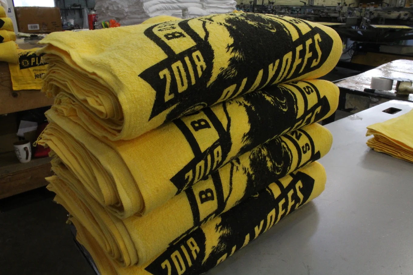 Stacked yellow printed apparel folded for production pickup or packing