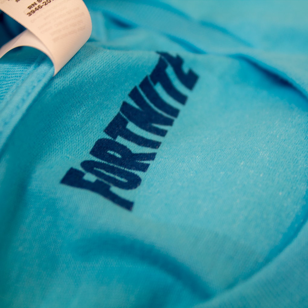 Close-up of blue sleeve print on a turquoise garment