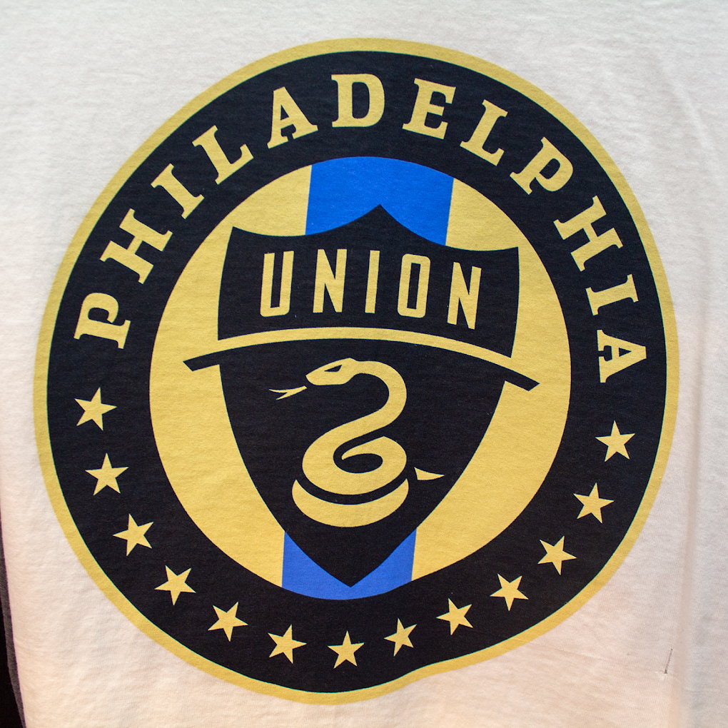 White t-shirt with circular soccer crest artwork