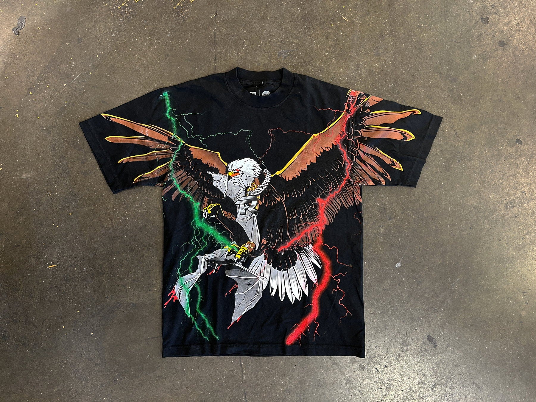 Black t-shirt with oversized eagle graphic and lightning print