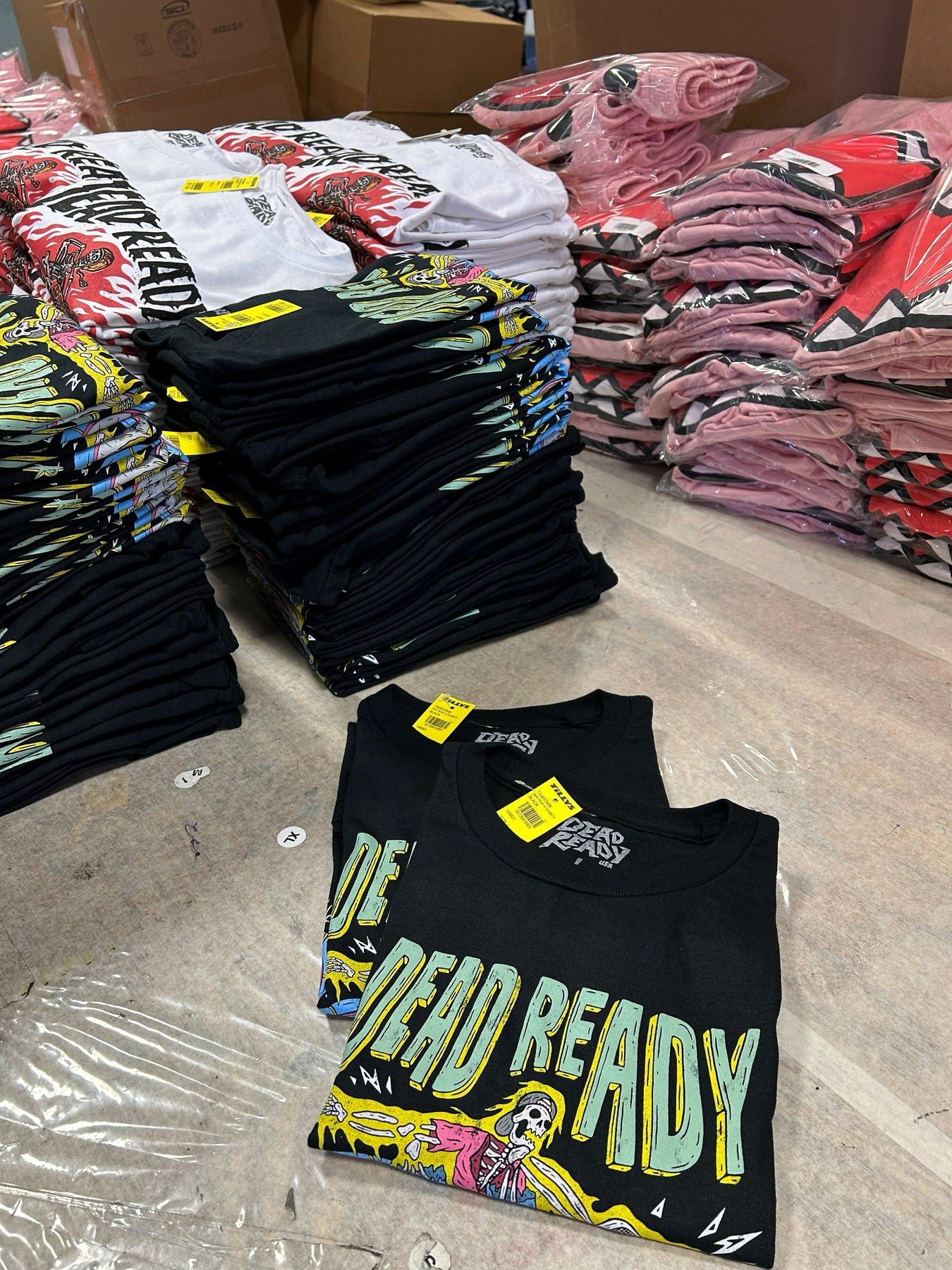 Folded printed apparel sorted and packed for a retail-ready merch batch